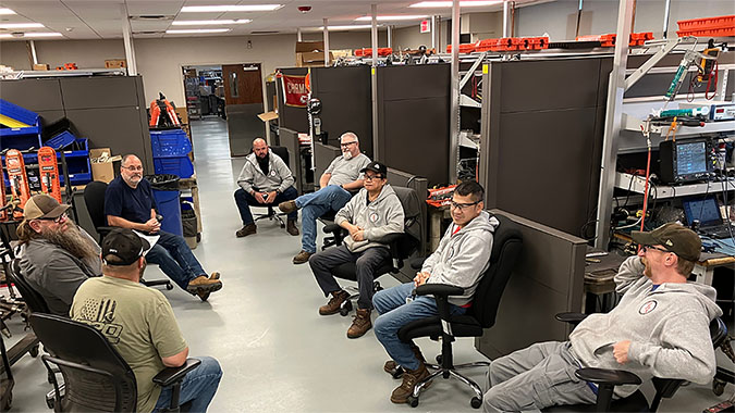 CRF team members talk safety during a briefing. From left to right: Daniel Spangler, Merlin “Skip” Dixon, Jeff Ost, Anthony Hall, Corey Croxell, Nam Nguyen, Ben Truong and Kyle Olson 
