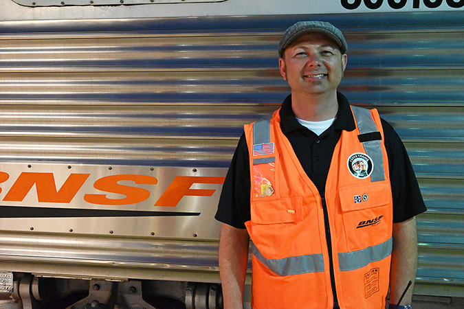 Ed Tumbas stands outside of one of BNSF&rsquo;s business cars on the 2023 Employee Appreciation Special trip.