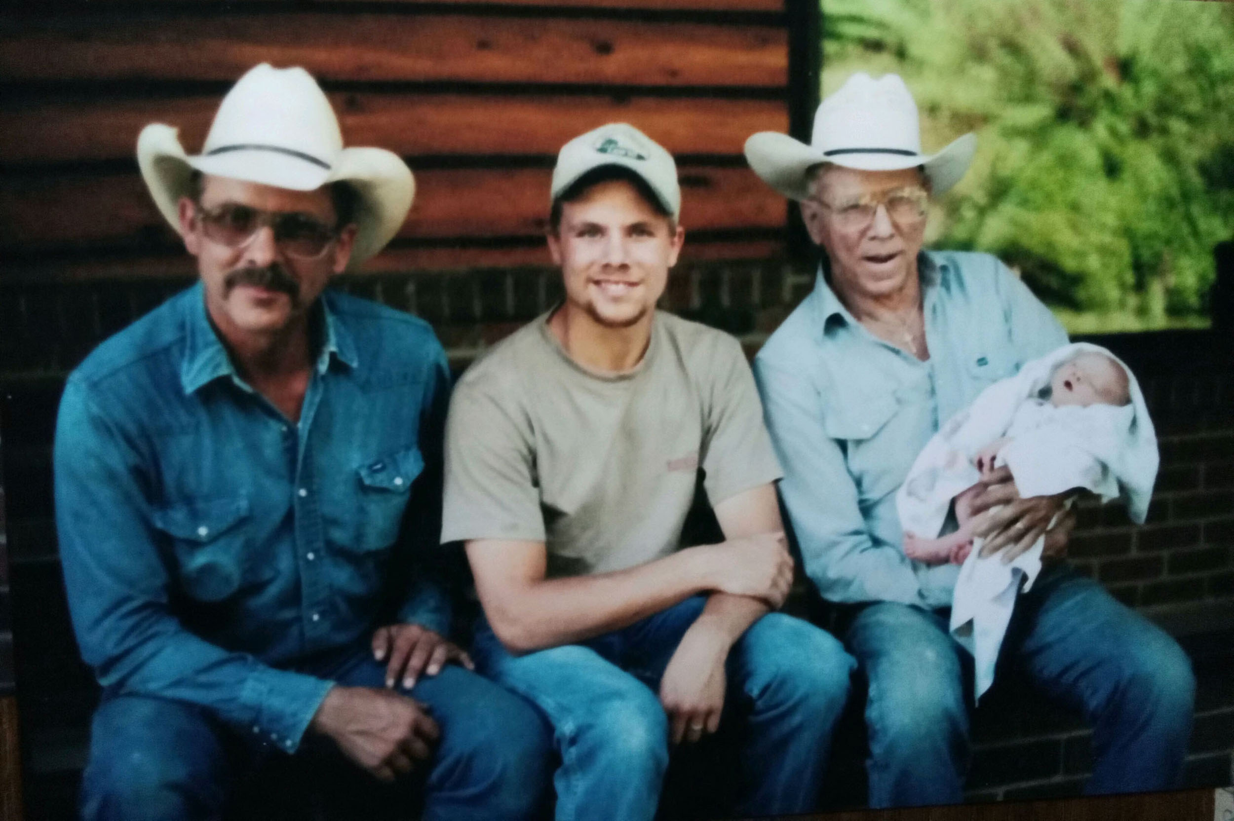 From left to right: Greg Hampson, Ben Hampson and Bill Hampson holding Ben&rsquo;s son, Thad