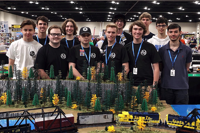 The EmpireLUG team collectively built the layout for the Brickworld Chicago convention. Front row (left to right): Lee Roberts, Anthony Davis, Ben Fillinger, Matt Welch, Gage Hunt, Andr&egrave;s Cazenave-Tapie Back row (left to right): Josh Bretz, Max Finnemore, Gavin Smith, Quinlan Barwick, Nolan T.