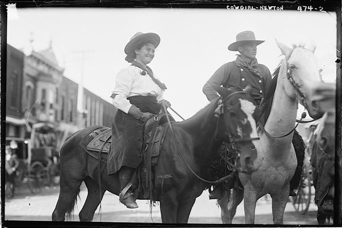Cowgirl riding through Newton in 1908 Cowgirl riding through Newton in 1908