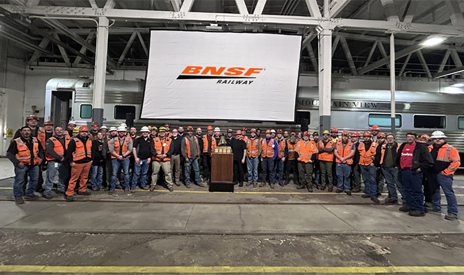 Team members at our Topeka System Maintenance Terminal gather around their bell. Team members at our Topeka System Maintenance Terminal gather around their bell.