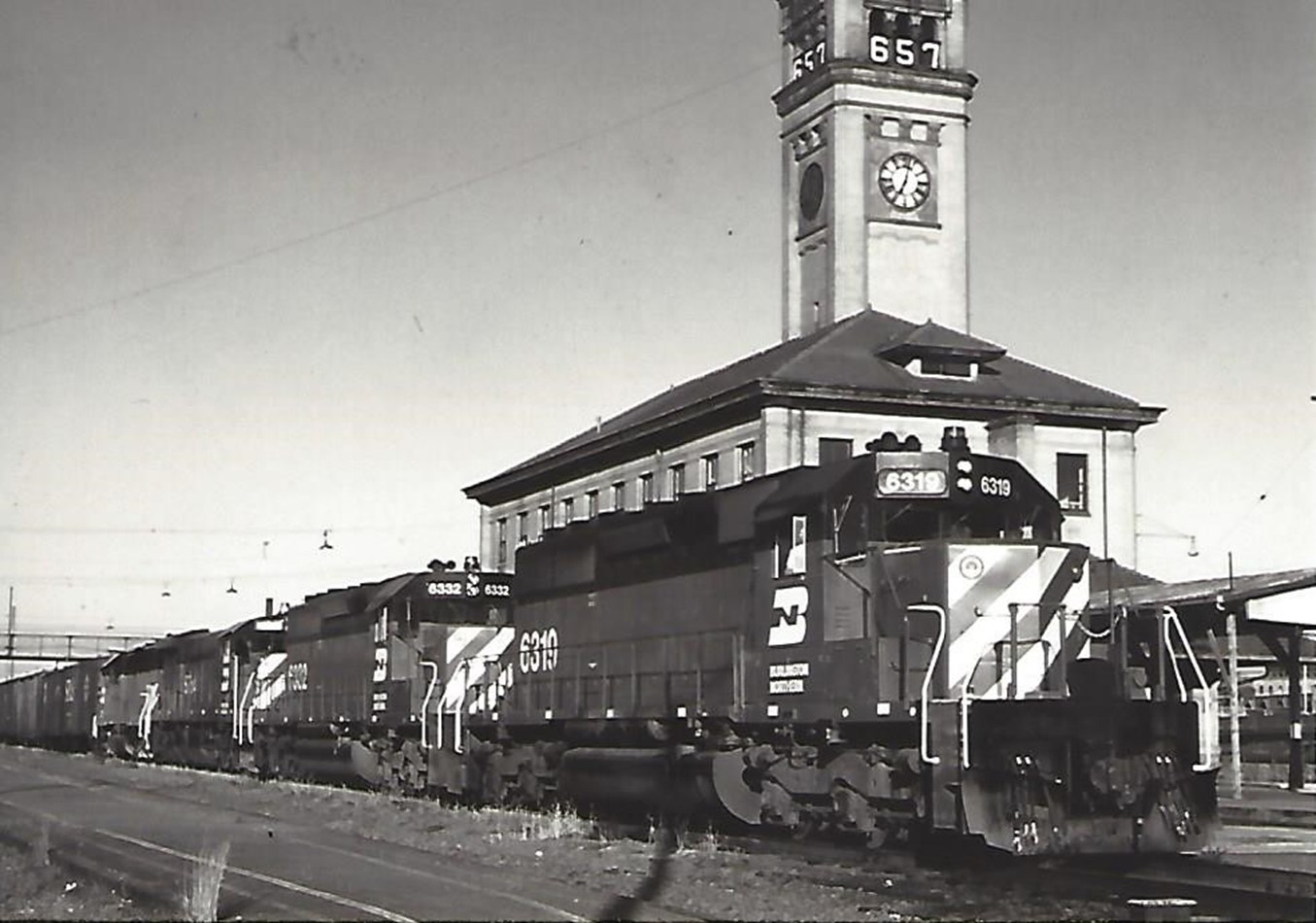 A Burlington Northern train at the Great Northern depot and clock tower, circa 1972. The &ldquo;657&rdquo; on the clock tower is a countdown clock, indicating 657 days until the start of the World&rsquo;s Fair/Expo.