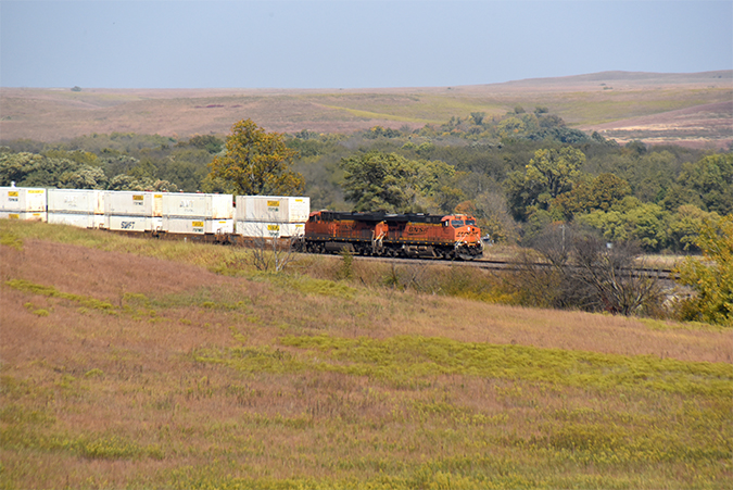 A BNSF intermodal train rolls through the Flint Hills near Hornbeck&rsquo;s route.