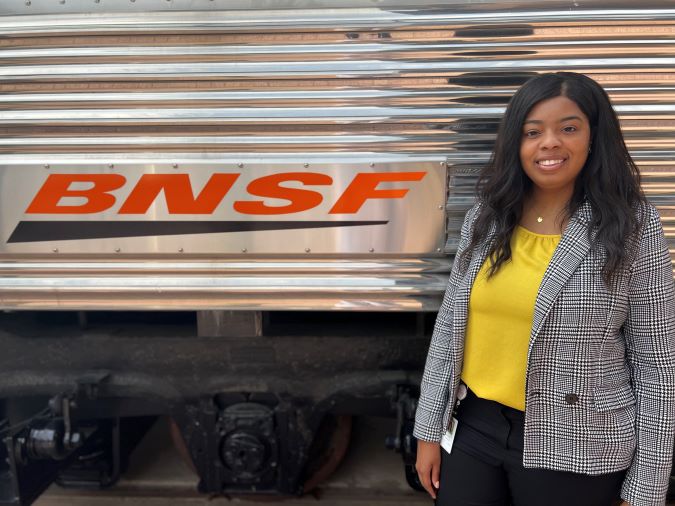 Jasmine Richard in front of a refurbished business car at BNSF&rsquo;s headquarters in Fort Worth.
